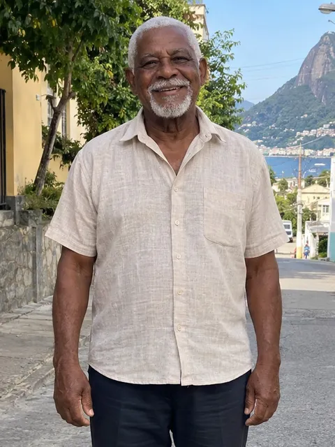 A fictional grandpa, waist-up, smiling at the camera